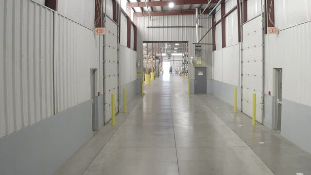 drone shot passing through a hallway in a factory