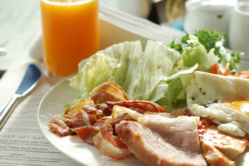 Traditional breakfast with bacon and fried eggs