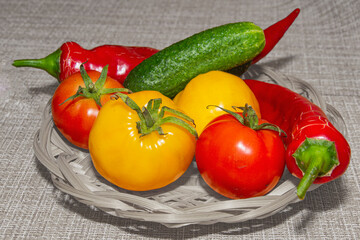 Cucumbers tomatoes and peppers on the background