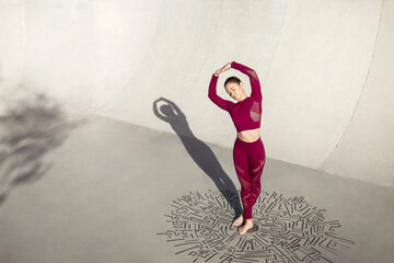 Caucasian beautiful female stretching at park with red sport clothing above puzzle black lines circle 