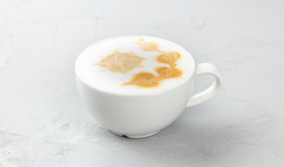 White cup of hot mochacino coffee on concrete background