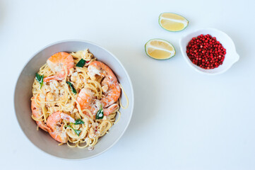 tasty healthy vegetarian dish - italian creamy basil shrimp pasta with pink pepper and lime