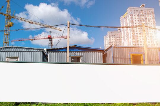 Large White Advertising Fence With Mockup Place On Construction Site Builders Houses Background