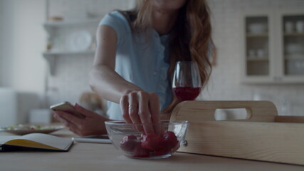 Closeup romantic woman enjoying strawberries in kitchen. Lady relaxing at home.
