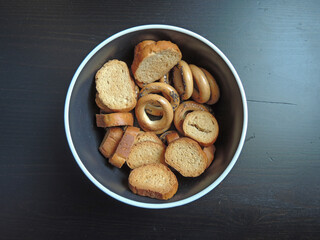 bagels and crackers on a black background.