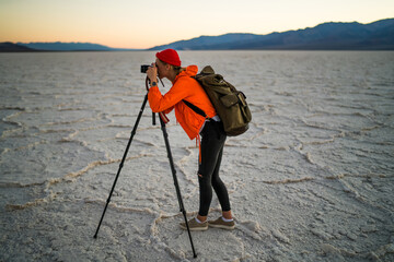 Unrecognizable traveler taking pictures on dried lake