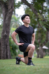 asian young man do lunge work out in the park