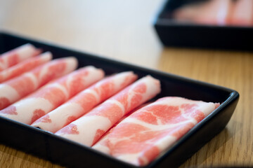 Thin of fresh streaky pork in black tray for hot pot