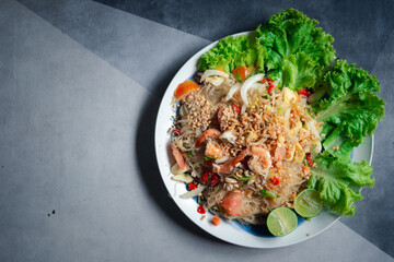 Thai spicy seafood salad with vermicelli and minced pork.