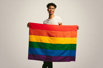 Queer man holding lgbtq flag