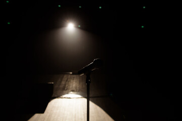 Close up of microphone on stage in black background