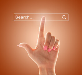 Index finger of a female hand points to the search field