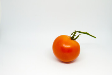 close up of red cherry tomato on a white background