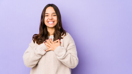 Obraz premium Young mixed race hispanic woman isolated laughing keeping hands on heart, concept of happiness.