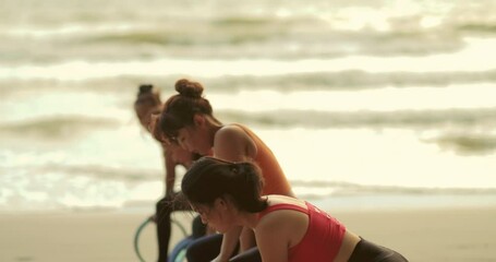 Professional group females yoga practice in class on mat stretching