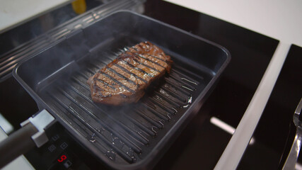 Close up of meat frayed on fraying pan on electric stove