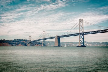 the san francisco bay bridge taken from s.f. on the left is yerba buena/treasure island.