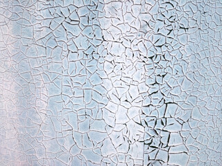 The texture of a painted blue wall that has cracked. Concept background, texture.