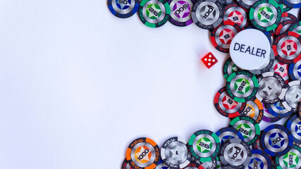 Pskov, Russia - 10.01.2020. Poker chips, dealer icon and dice  for casino game on a white background. Casino chips frame