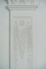 White ornament on a white wall. Architectural elements for interior wall design. High quality photo.
