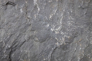 Closeup of rock surface textured in abstract pattern background.