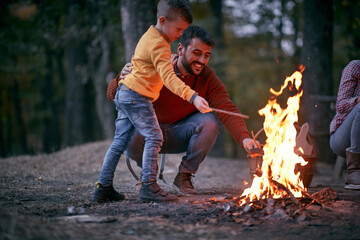 Father and son starting a fire; Quality family time concept