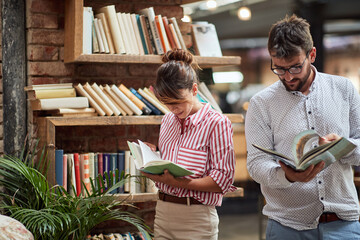 A young couple browsing books at a cafe