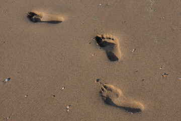 Three footprints in the sand