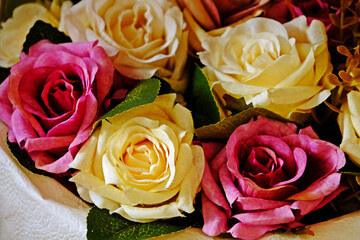 Variety of beautiful blooming artificial roses for home decoration.