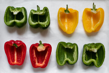 Four Halved Bell Peppers on Parchment Paper