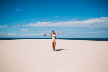 Fototapeta na wymiar Woman walking on beach near sea