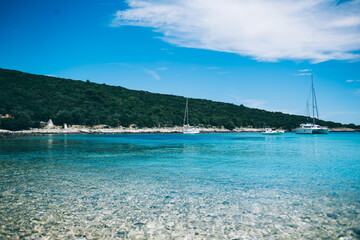 Yachts floating near sea shore