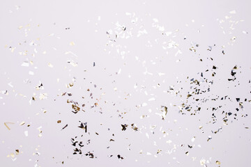 Gold and silver sparkles and glitter on off white trendy background. Festive backdrop for your projects.