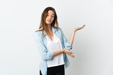 Young Ireland woman isolated on white background extending hands to the side for inviting to come