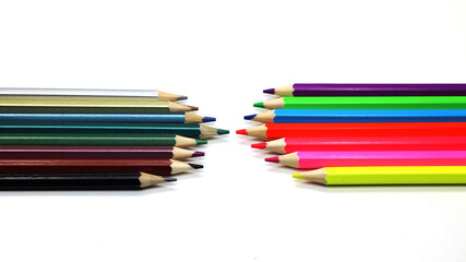 colored pencils lie opposite each other on a white background, isolated, close-up, macro