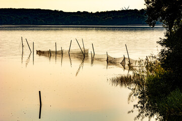 Beautiful sunset scenery of a fishing net in a lake one of the latest days of summer. Picture from Ringsjon, Scania, Sweden. 