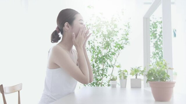 Asian young woman checking her skin