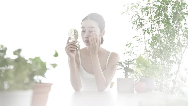 Asian young woman checking her skin