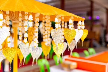 Several golden Pho tree leaves are hanging for decoration. Pho leaf, silver & gold For allusions