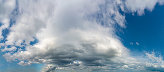 Fantastic clouds against blue sky, panorama