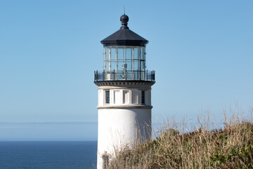 Close up of North Head Lighthouse at Cape Disappointment on the Pacific Ocean with a clear blue sky sunny day.