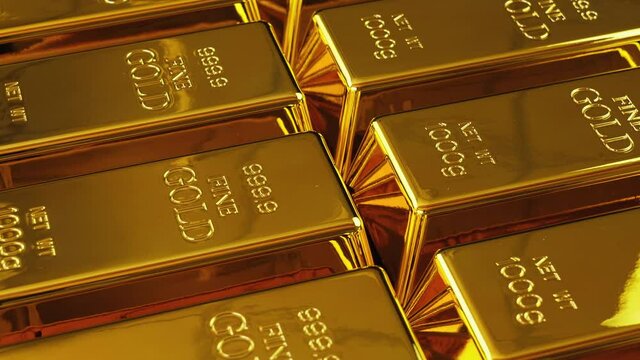 Gold bricks. Stack of gold bullion bars. Seamless looping footage. Gold bars stacked in a row. The camera pans around gold bars in close up.