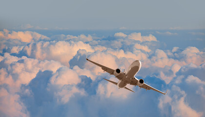 Passenger airplane over the clouds - Travel by air transport 