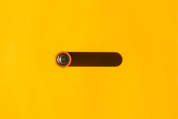 battery with a hard shadow on a plain background. the view from the top. blank for the pattern