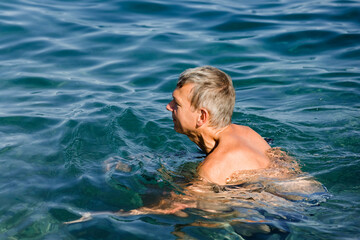 Mature man swimming in sea