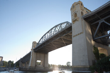 Burrard Bridge in the morning in Vancouver, British Columbia, Canada. Steel truss bridge over False Creek with imposing concrete towers.