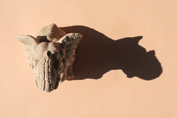 elephant statuette with a hard shadow on a plain background. the view from the top. blank for the pattern