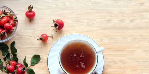 Rosehip tea with rosehip fruit in a glass Cup, light background, space for text