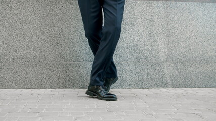 Closeup man feet dancing outside. Cropped image man in shoes dancing at street