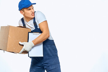 Man worker with box in hands delivery loading service work light background